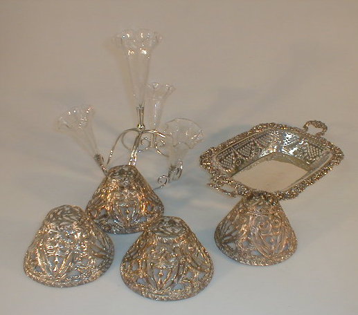 Appraisal: Four pierced stamped metal candle shades an electroplated basket of