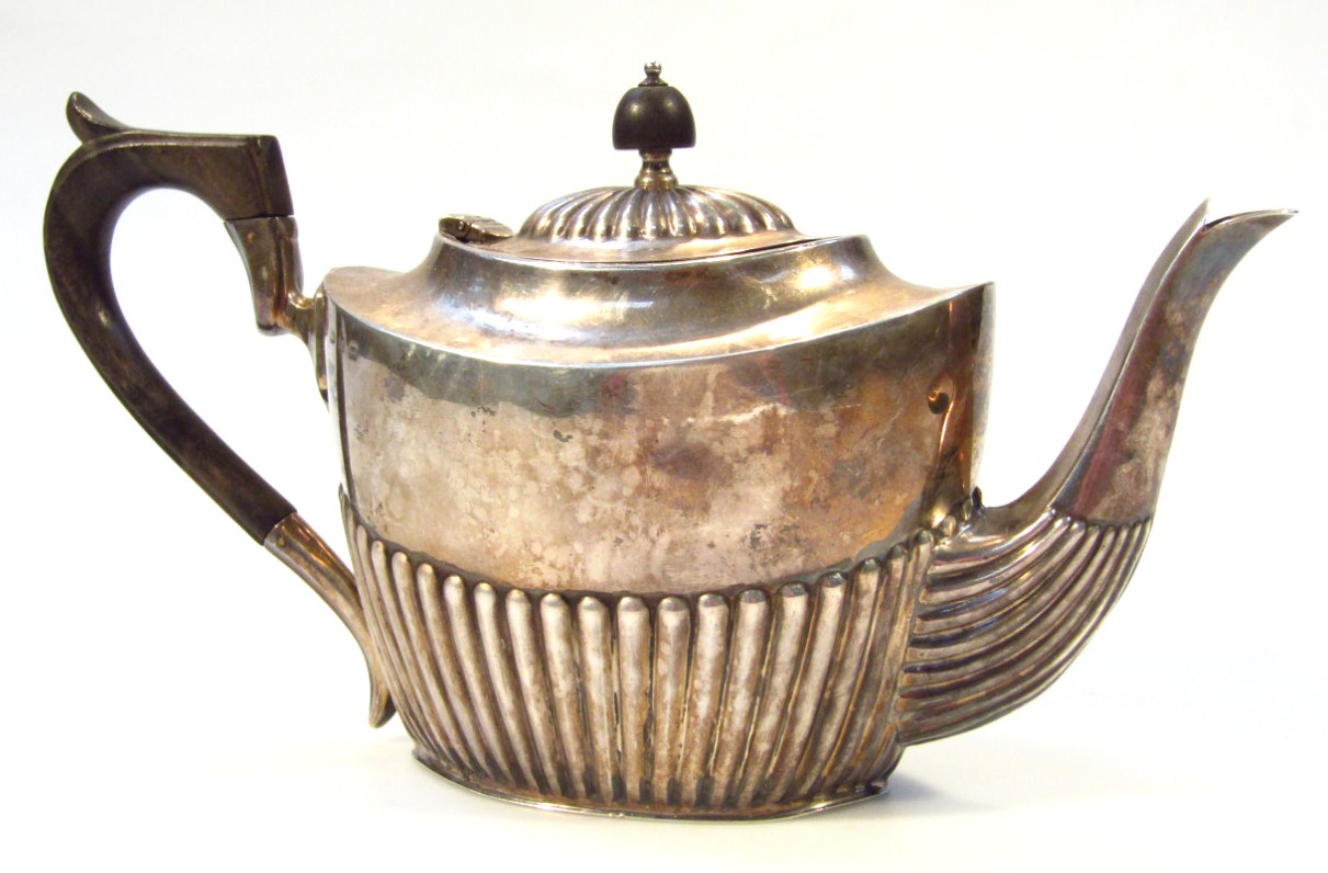 Appraisal: A Victorian silver teapot of part gadrooned outline with ebonised