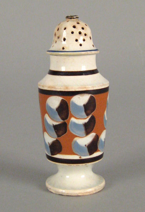 Appraisal: Mocha pepper pot with cat's eye decoration on a tan