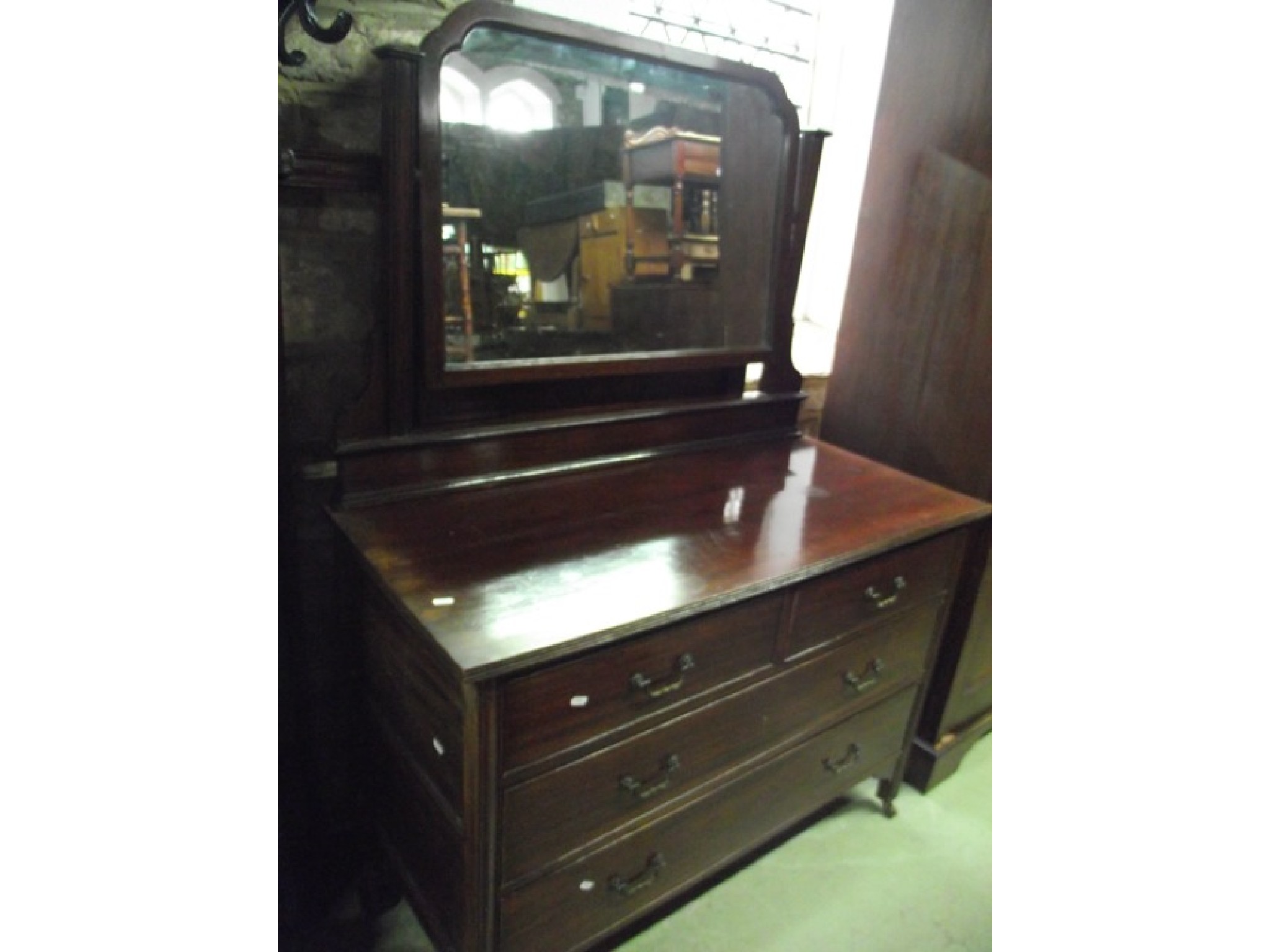 Appraisal: An Edwardian mahogany triple wardrobe with dentil cornice over three