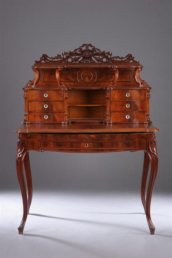 Appraisal: GERMAN ROCOCO REVIVAL MAHOGANY DESK - Crested with serpentine ledge