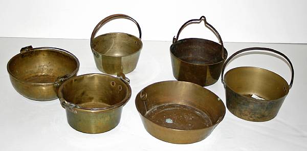 Appraisal: A grouping of brass and iron pots and vessels Including