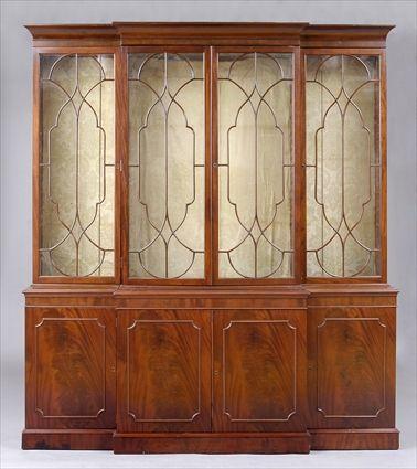 Appraisal: GEORGE III CARVED MAHOGANY BREAKFRONT BOOKCASE The coved cornice of