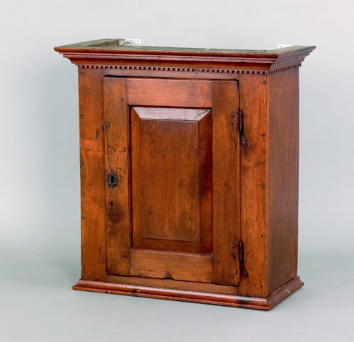 Appraisal: Pennsylvania walnut hanging cupboard late th c with a raised