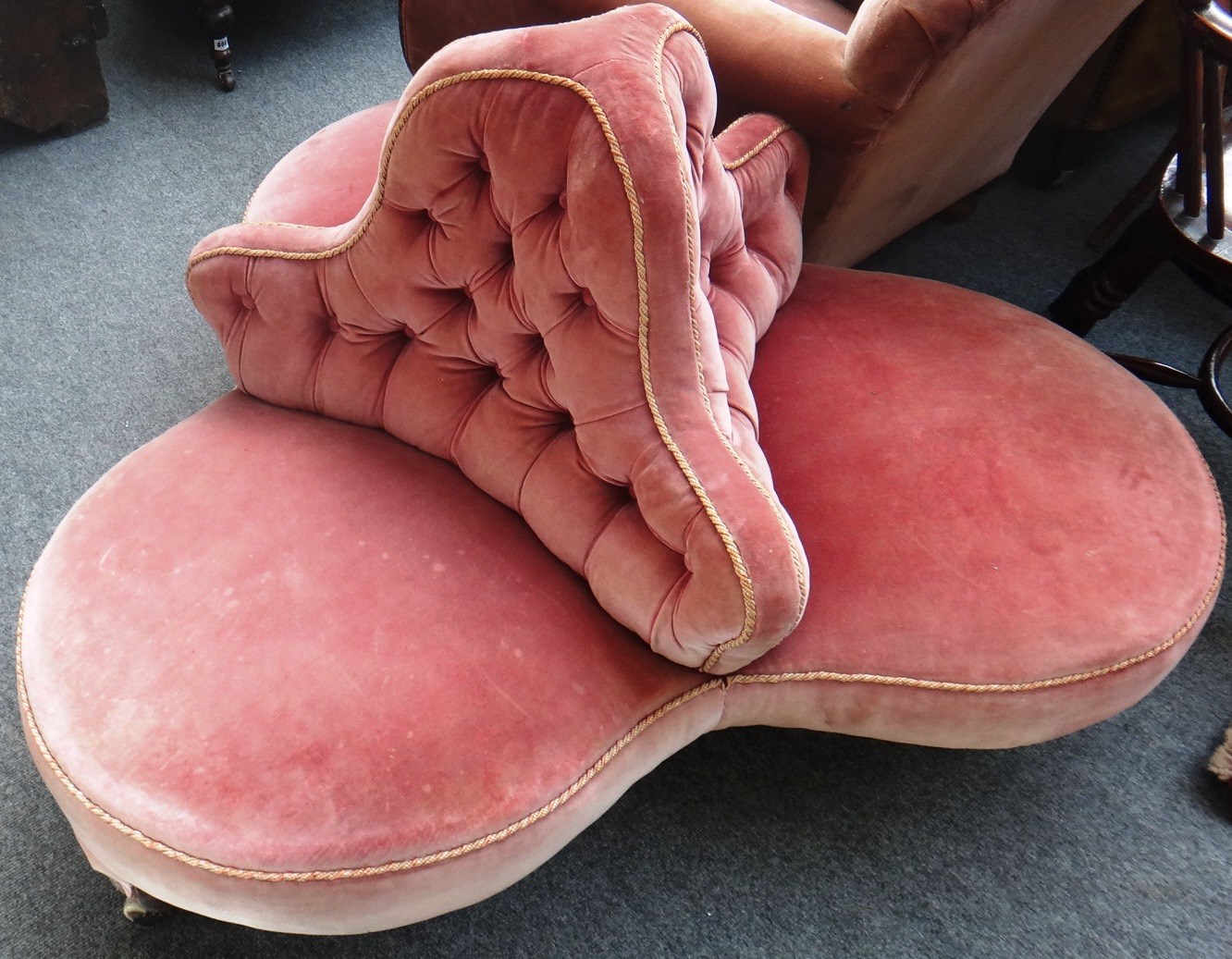 Appraisal: A Victorian quatrefoil button back conversation sofa on turned mahogany