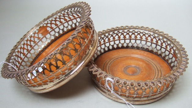 Appraisal: A pair of plated metal mounted bottle coasters with pierced