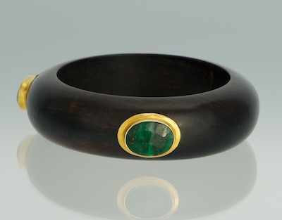 Appraisal: A Carved Mahogany Bangle Bracelet with Green Quartz Cabochons Carved