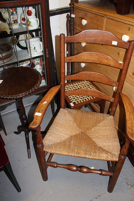 Appraisal: A TH CENTURY RUSH SEATED LADDERBACK ARMCHAIR standing on turned