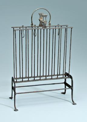 Appraisal: Wrought iron toasting rack one side hinged above penny feet