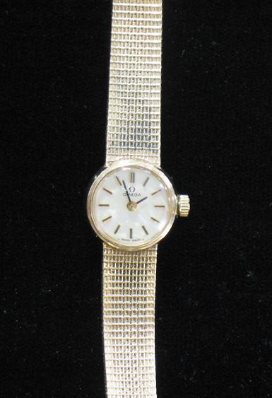 Appraisal: A LADY'S OMEGA WRISTWATCH the dial with raised batten numerals