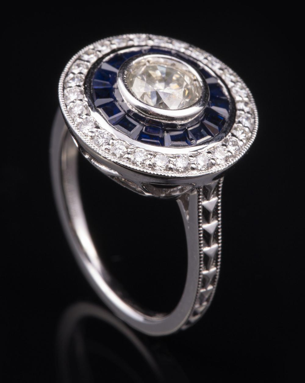 Appraisal: Platinum Diamond and Blue Sapphire Ring center bezel set round