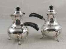 Appraisal: A pair of late Victorian crested silver cafe au lait