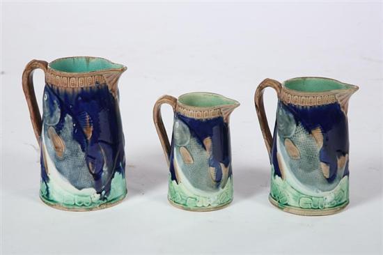 Appraisal: THREE MAJOLICA PITCHERS English nd half- th century Graduated JRL