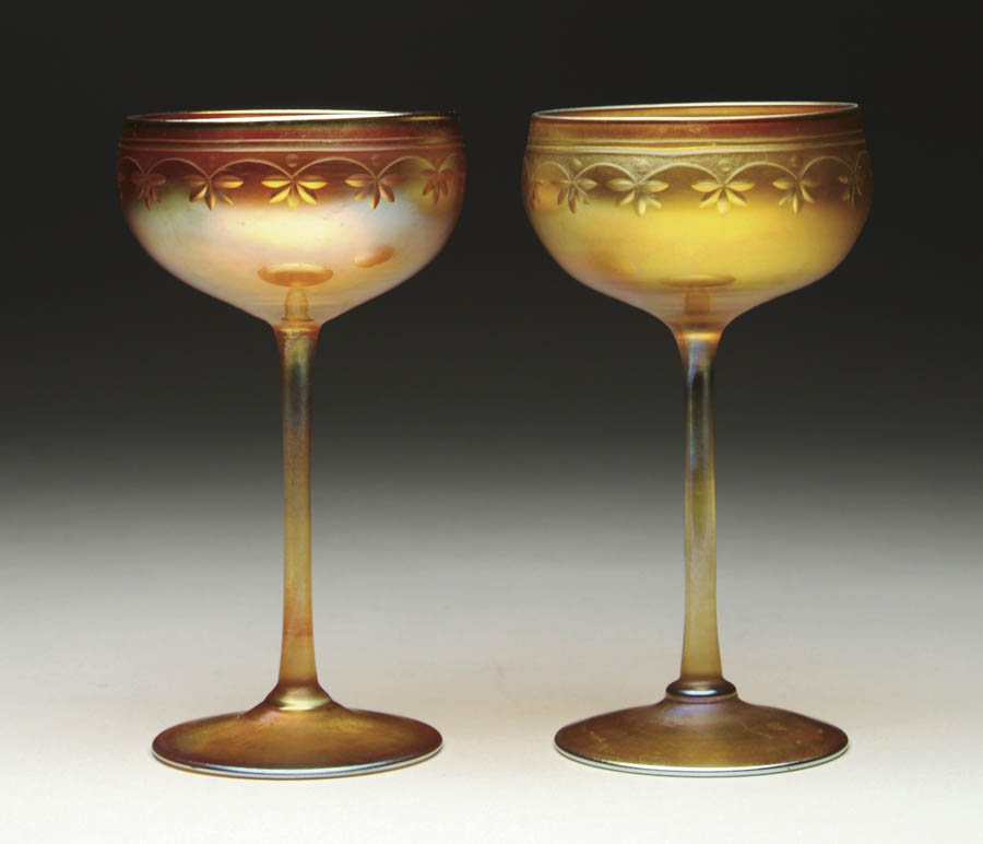 Appraisal: PAIR OF TIFFANY WINE GLASSES Gold iridescent with wheel-carved stylized