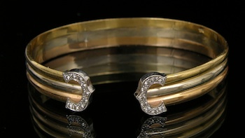 Appraisal: A Tri-Color Gold Cuff Bracelet This cuff bracelet features k