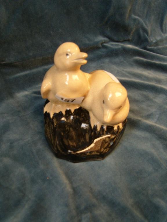 Appraisal: A group of a pair of cream glazed ducklings raised