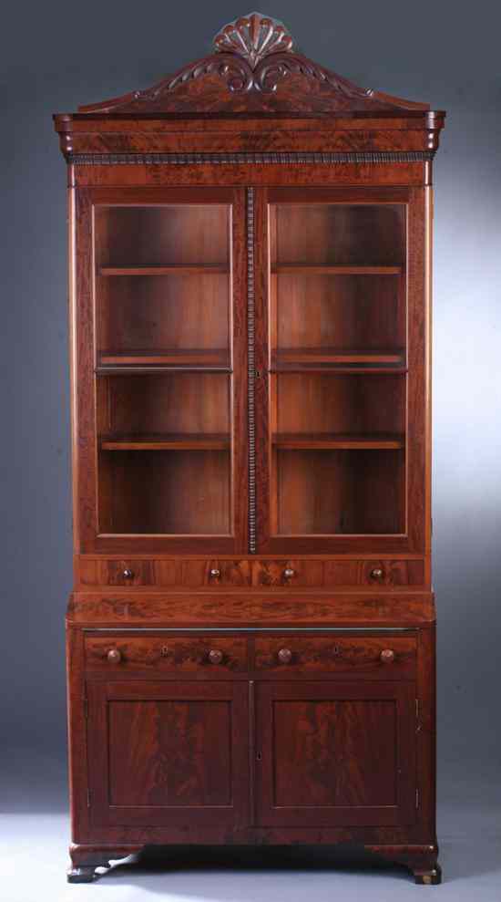 Appraisal: EMPIRE FLAME MAHOGANY SECRETARY BOOKCASE th century Carved shell and