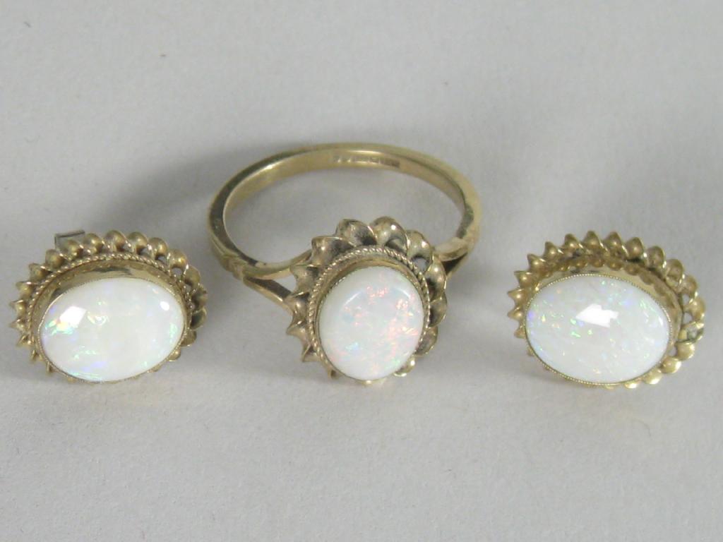 Appraisal: An Opal Dress Ring the oval cabochon collet-set within twisted