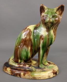 Appraisal: Redware cat Redware seated cat with green and brown mottled