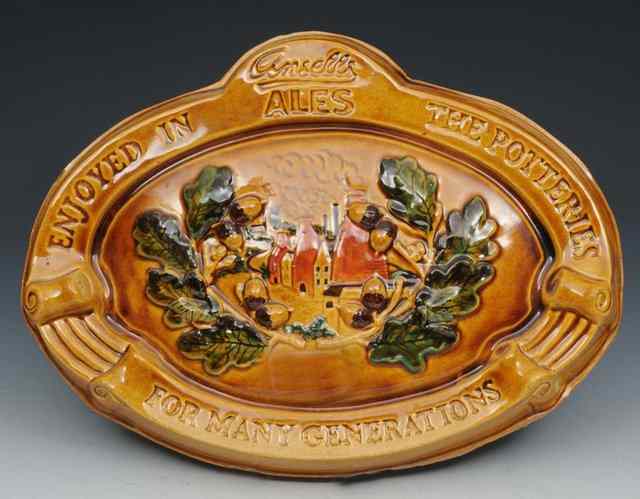 Appraisal: ADVERTISING AN ANSELLS ALES GLAZED POTTERY WALL PLAQUE 'Enjoyed in