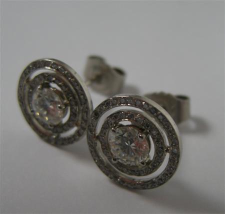 Appraisal: A pair of all diamond cluster earrings each claw set