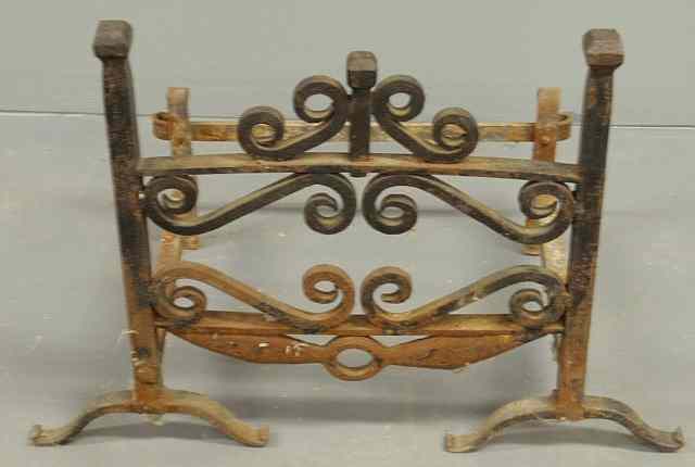 Appraisal: Wrought iron scroll decorated log holder with arched front legs