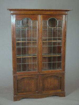 Appraisal: An oak lead glazed bookcase early th century with panelled