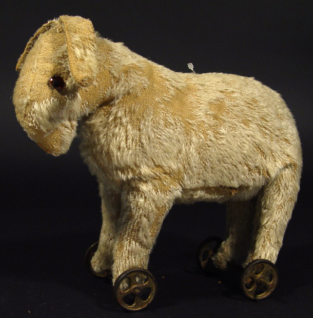 Appraisal: Edwardian childs straw filled donkey with metal wheels to the