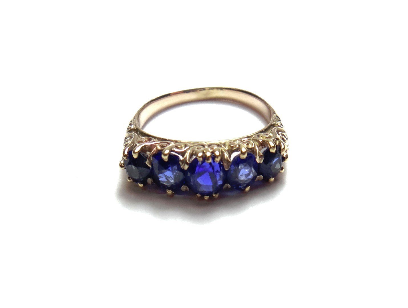 Appraisal: A gold and sapphire set five stone ring claw set