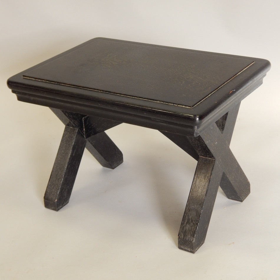 Appraisal: A small ebonised stool or occasional table on x shaped