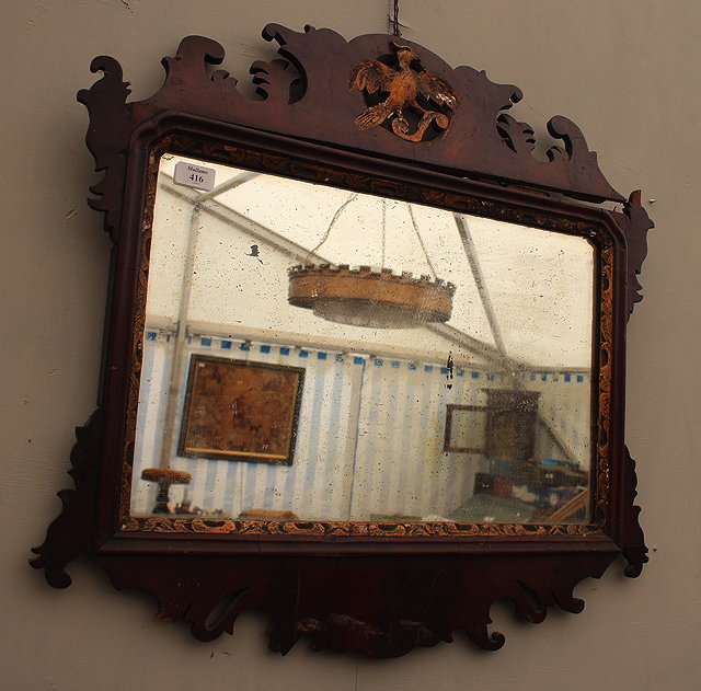 Appraisal: AN OLD MAHOGANY FRET FRAMED WALL MIRROR with ho-ho bird