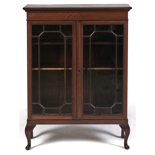 Appraisal: An Edwardian mahogany and broken line inlaid bookcase fitted with