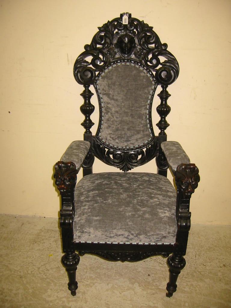 Appraisal: A VICTORIAN CARVED AND EBONISED OAK THRONE upholstered in a