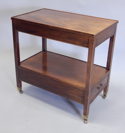 Appraisal: A mahogany two tier trolley with a frieze drawer on