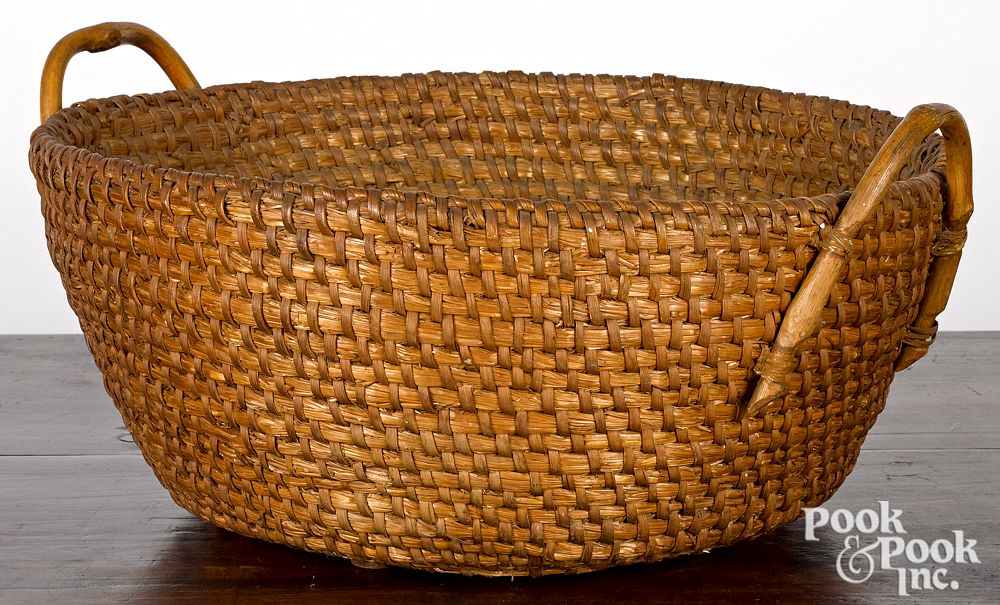 Appraisal: Large handled rye straw basket th c Large handled rye