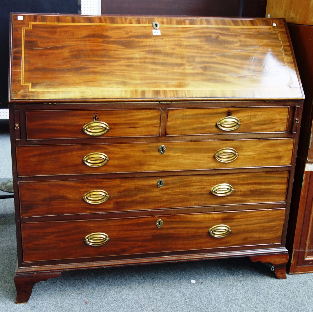 Appraisal: A George III inlaid mahogany bureau the fall enclosing a