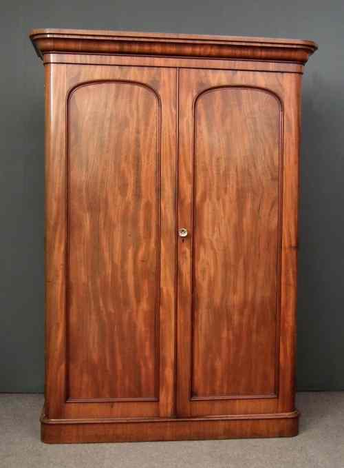 Appraisal: A Victorian figured mahogany wardrobe with rounded front corners the