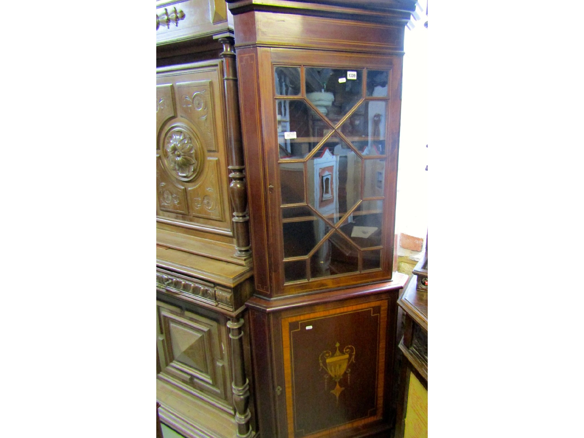 Appraisal: An Edwardian mahogany free standing two sectional corner cabinet with