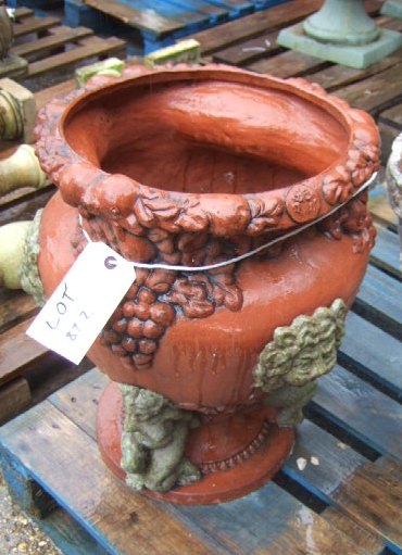 Appraisal: A terracotta garden pot the rim moulded with fruiting vines