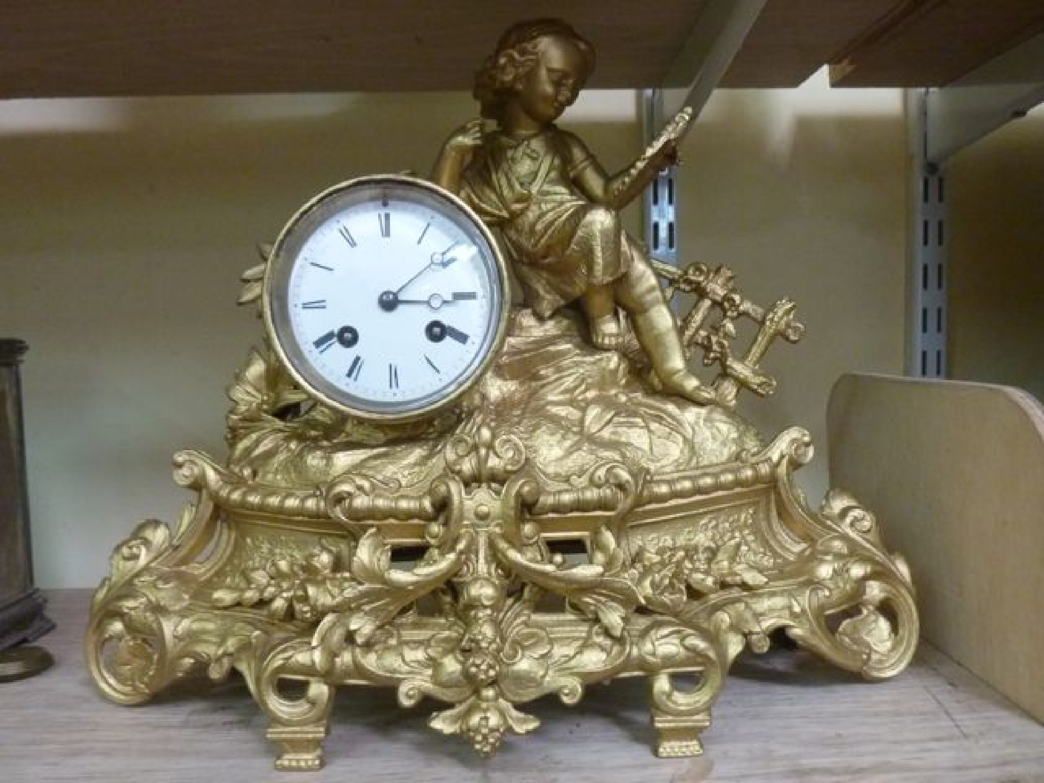 Appraisal: A th century gilded mantle clock of romantic form showing