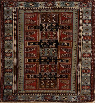 Appraisal: PERSIAN RUG The wine red field with conjoined cruciform medallion