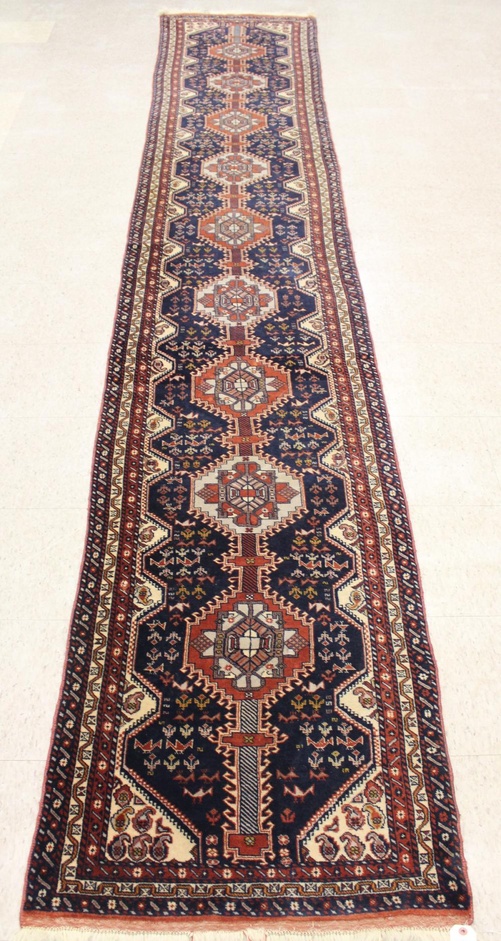 Appraisal: HAND KNOTTED ORIENTAL RUNNER featuring a column of nine octagonal