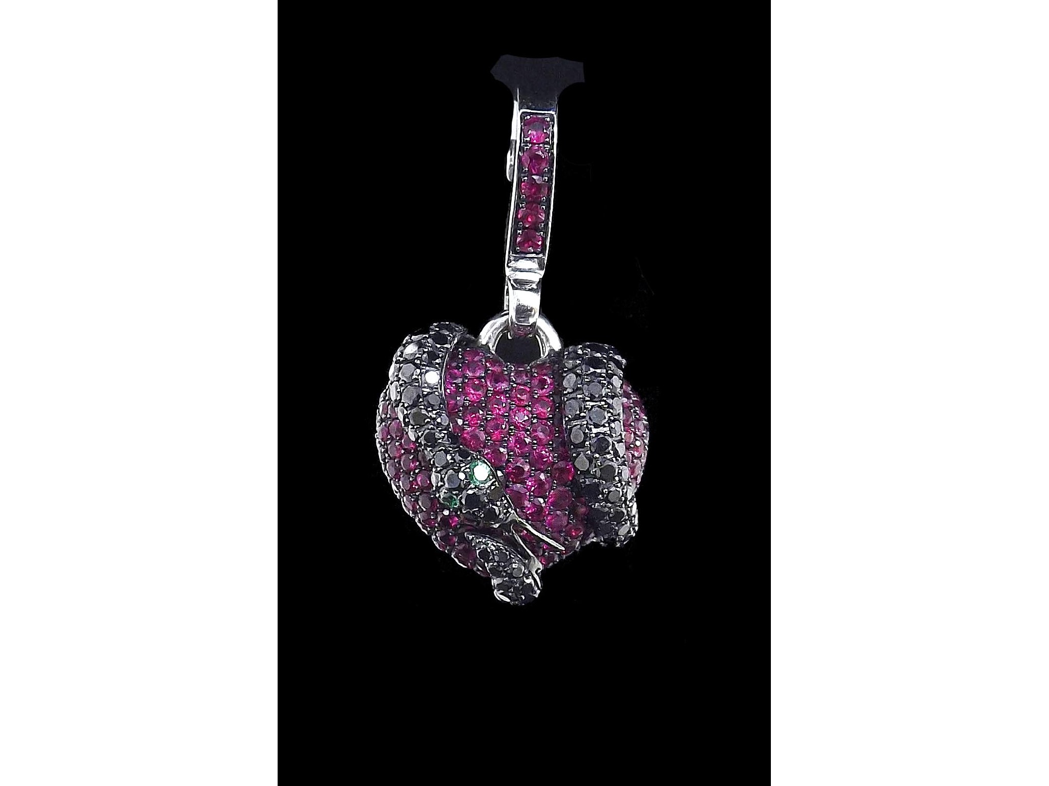 Appraisal: Theo Fennell black diamond and ruby set heart snake pendant