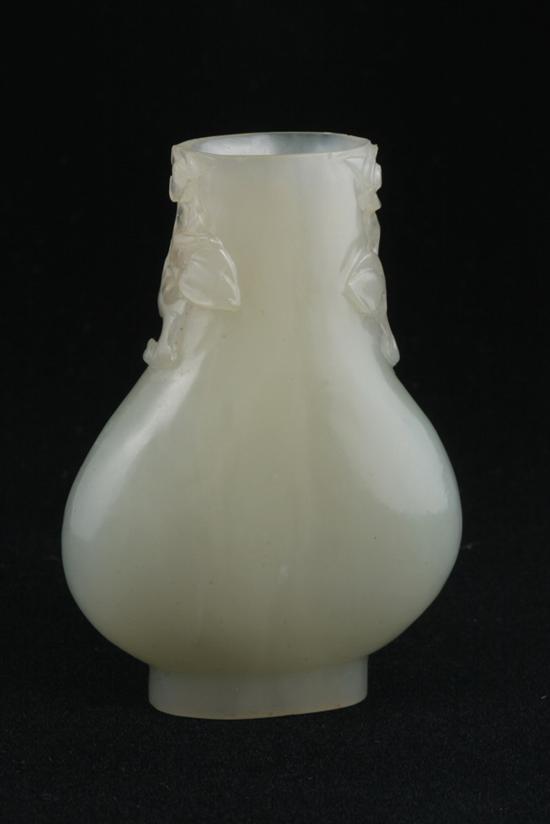 Appraisal: CHINESE CELADON JADE VASE th century Flattened ovoid form flanked