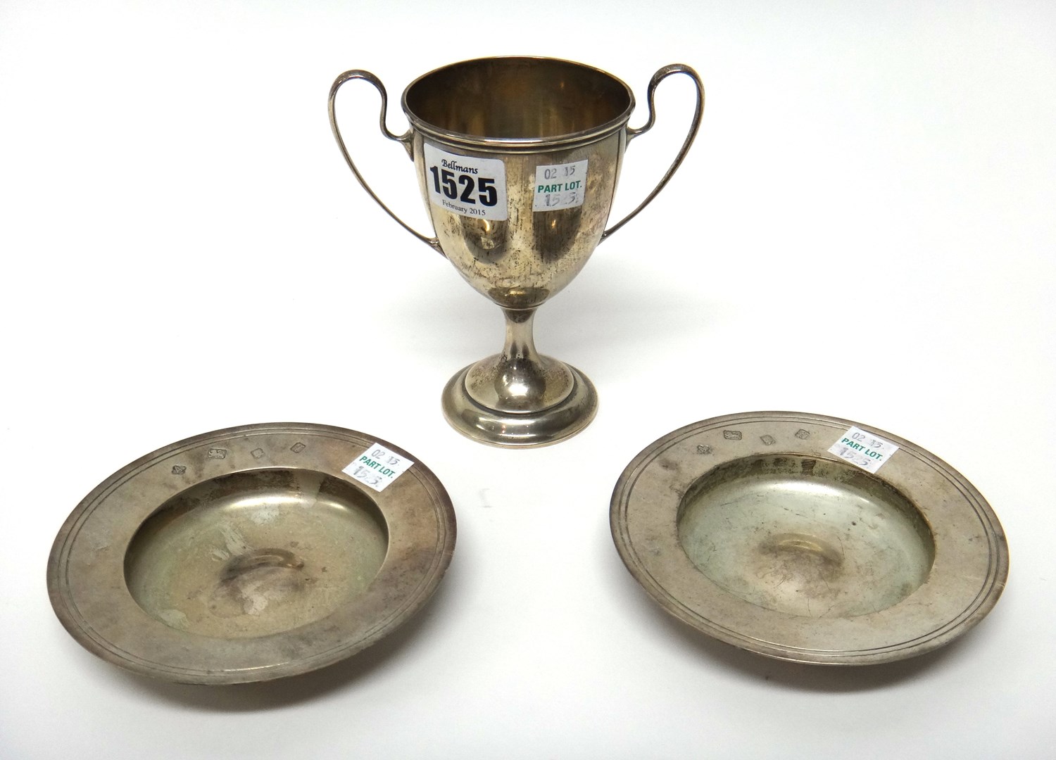 Appraisal: A silver twin handled trophy cup detailed Sterling and two