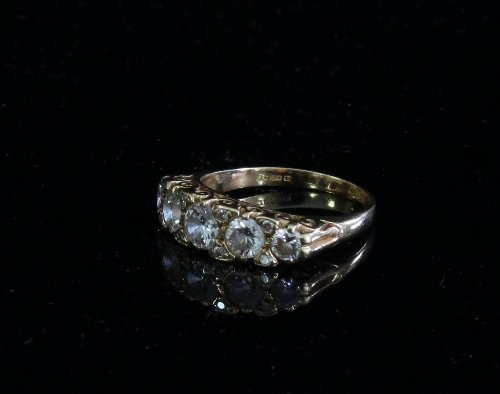 Appraisal: A diamond five-stone ring in an ct gold scroll setting