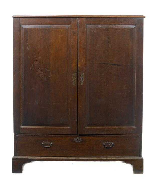 Appraisal: A GEORGE III OAK LINEN PRESS the pair of panelled