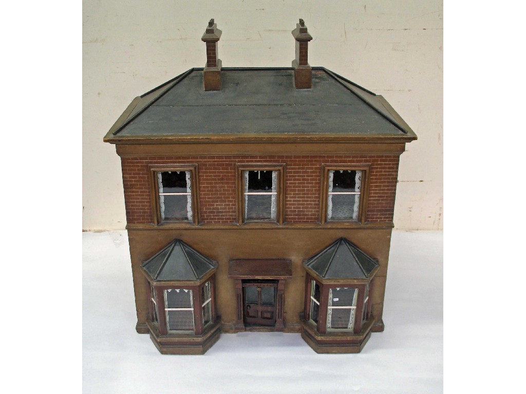 Appraisal: A Victorian dolls house with bay windows and painted brickwork