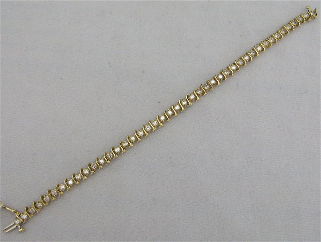 Appraisal: DIAMOND AND FOURTEEN KARAT GOLD BRACELET with round-cut diamonds together