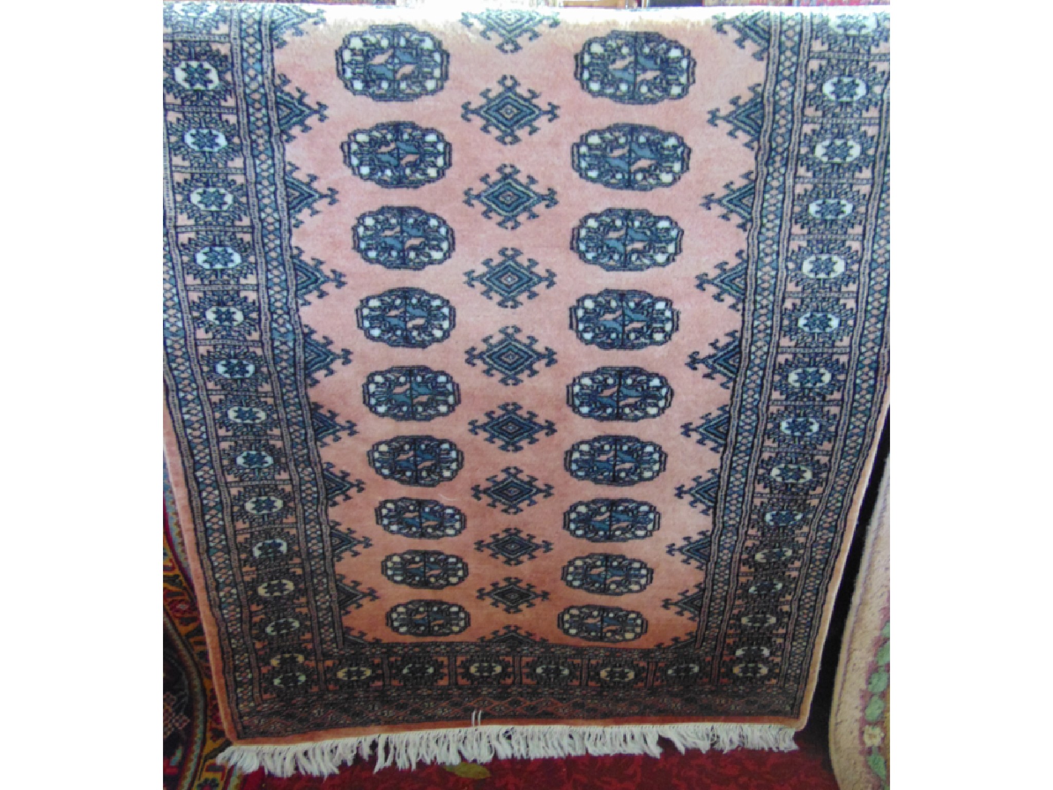 Appraisal: An Afghan style wool rug with pale pink field multi